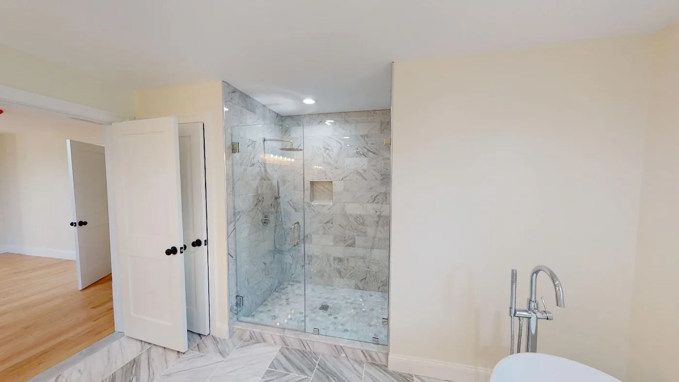 Glass shower with marble tile & niche