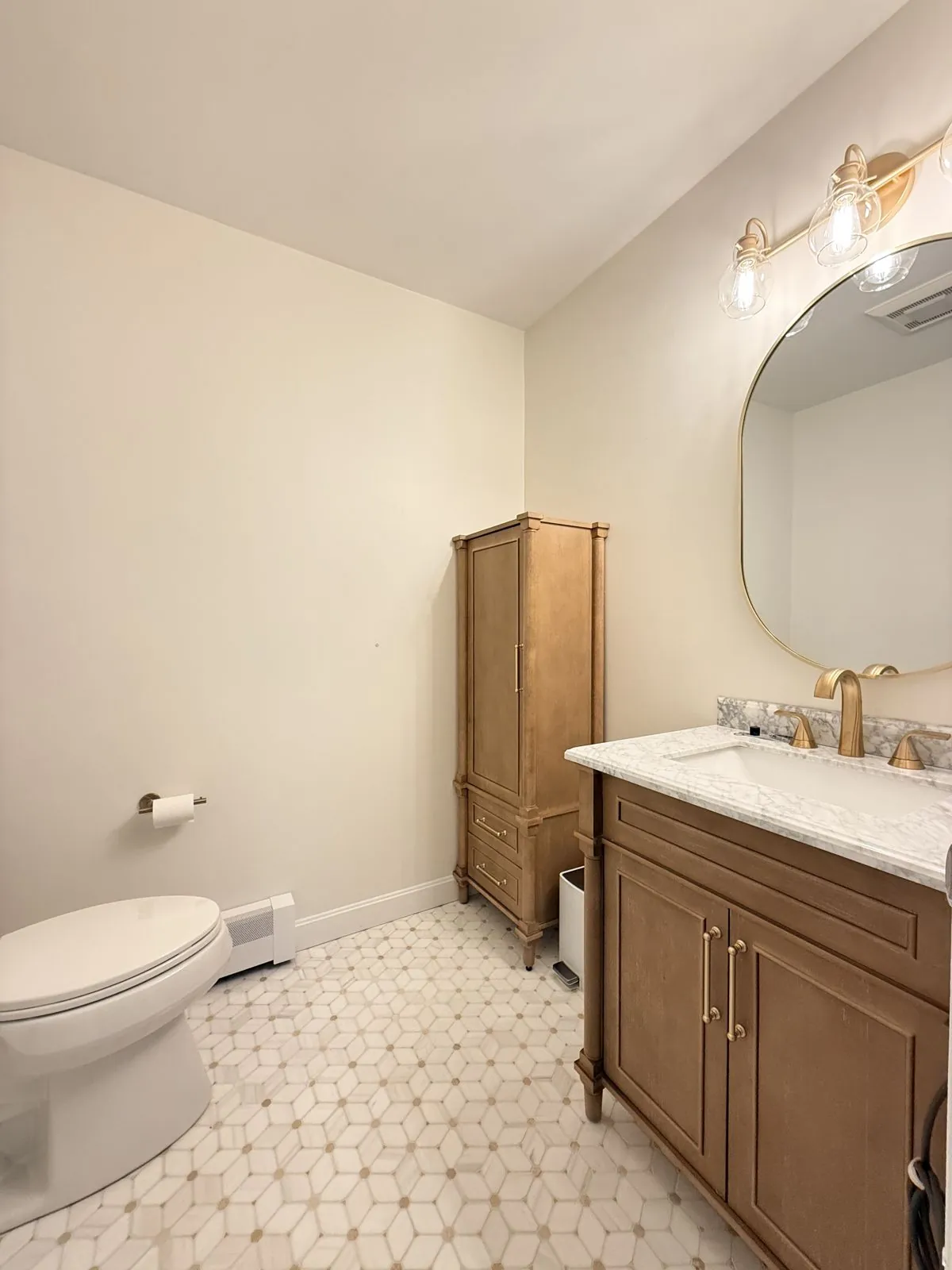 Wood vanity, gold fixtures & marble mosaic floor