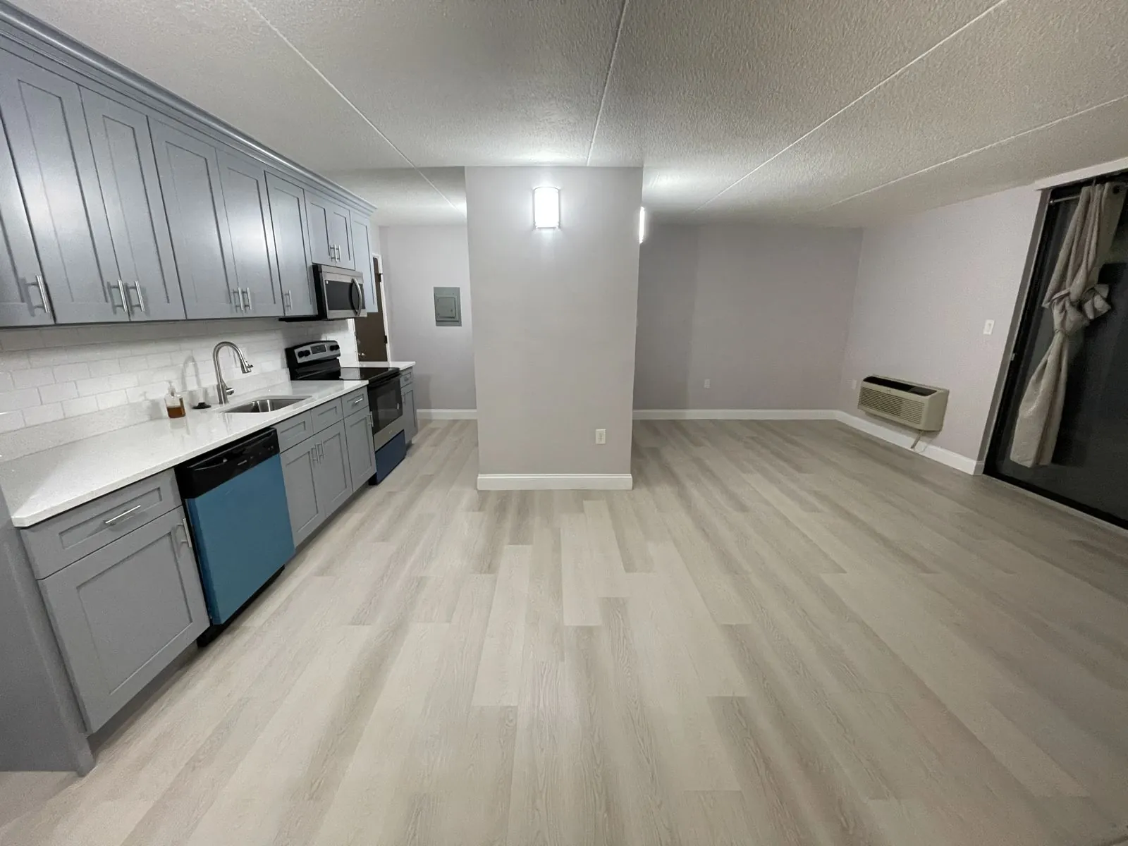 Open kitchen with gray shaker cabinetry